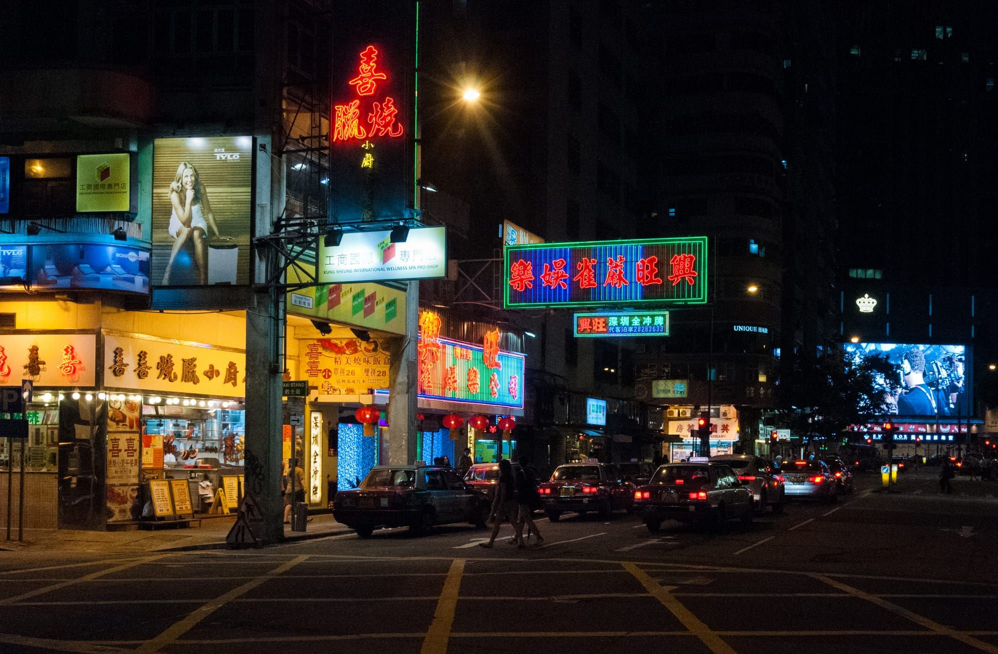 A busy Hong Kong street with shop signs at night